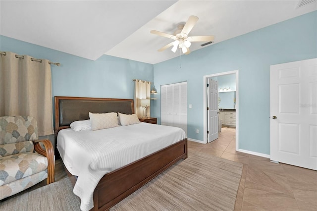 tiled bedroom featuring ceiling fan, connected bathroom, and a closet