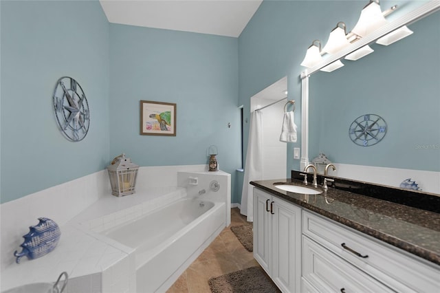 bathroom featuring vanity, a washtub, and tile patterned floors