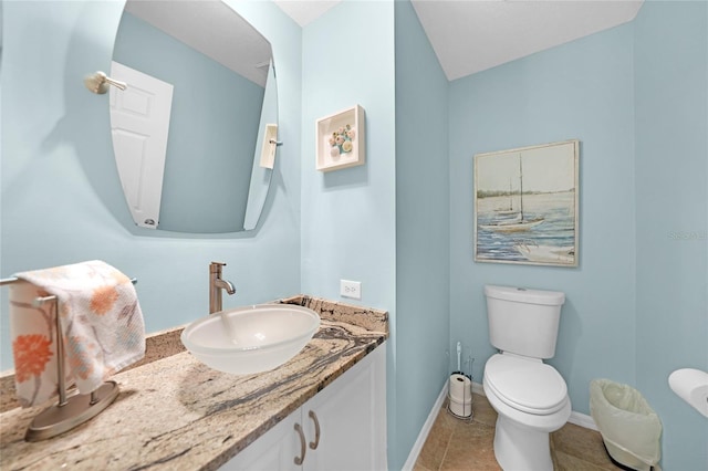 bathroom featuring vanity, tile patterned floors, and toilet