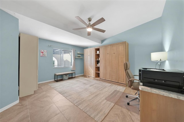 tiled home office featuring ceiling fan