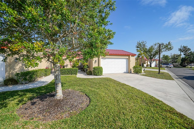 obstructed view of property with a garage and a front lawn