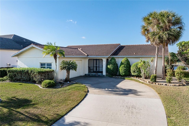 view of front of house with a garage and a front lawn