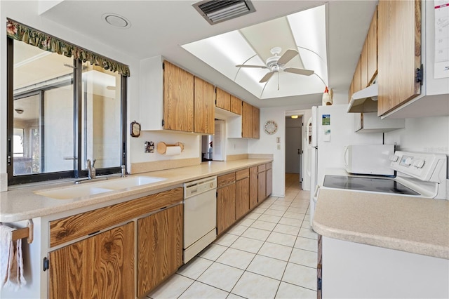 kitchen featuring light tile patterned flooring, ceiling fan, white dishwasher, and sink