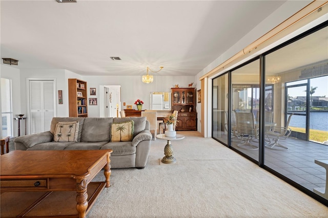 living room featuring a notable chandelier and a water view