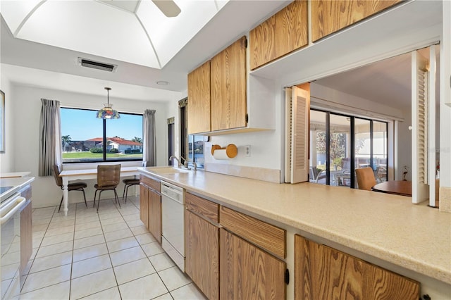 kitchen with sink, range with electric stovetop, light tile patterned floors, white dishwasher, and pendant lighting