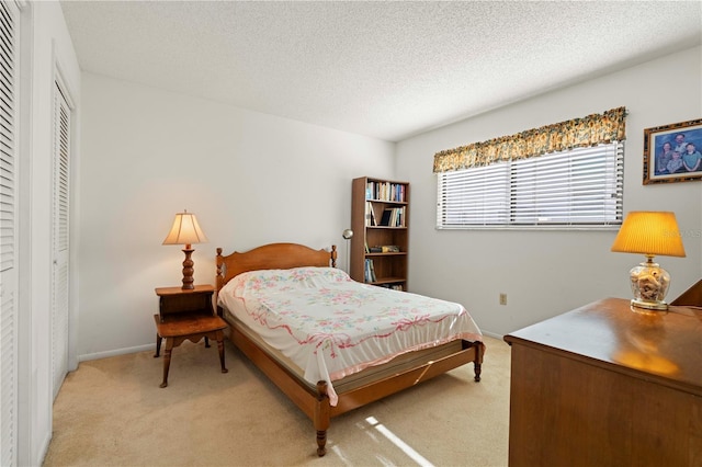 carpeted bedroom with a closet and a textured ceiling