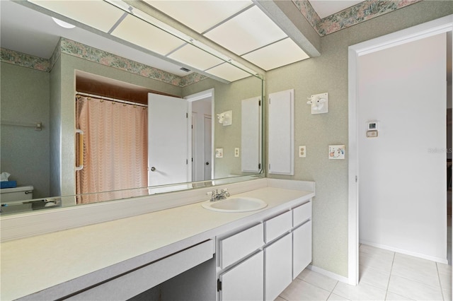 bathroom with tile patterned floors, vanity, and toilet