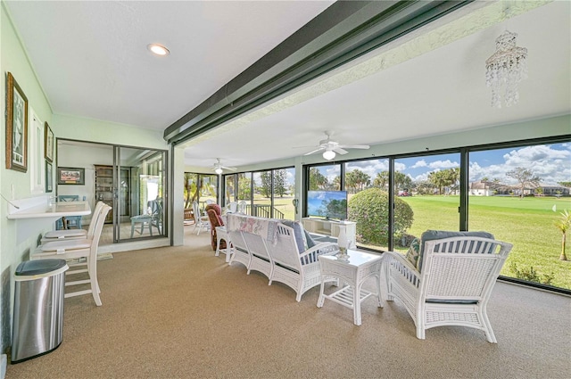 sunroom featuring ceiling fan