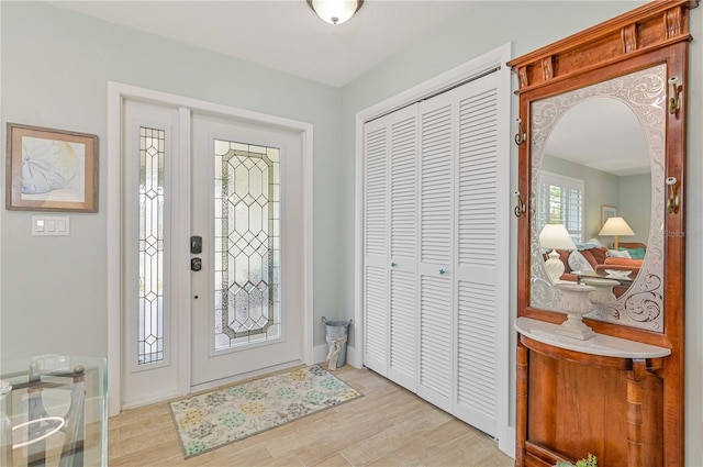 foyer entrance with light hardwood / wood-style floors