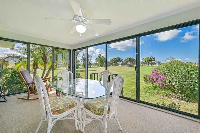 unfurnished sunroom with ceiling fan and a healthy amount of sunlight