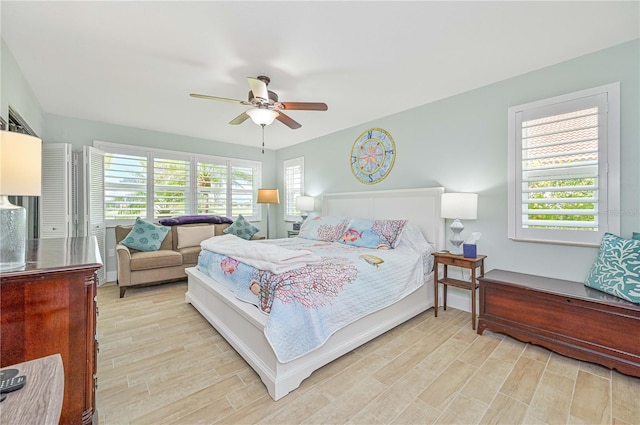 bedroom with ceiling fan and light wood-type flooring