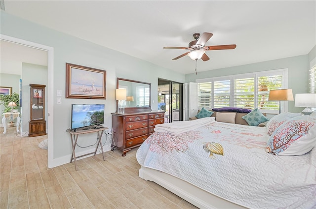 bedroom featuring ceiling fan, a closet, light hardwood / wood-style floors, and multiple windows