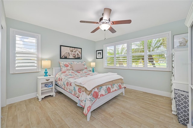 bedroom with ceiling fan and light hardwood / wood-style floors