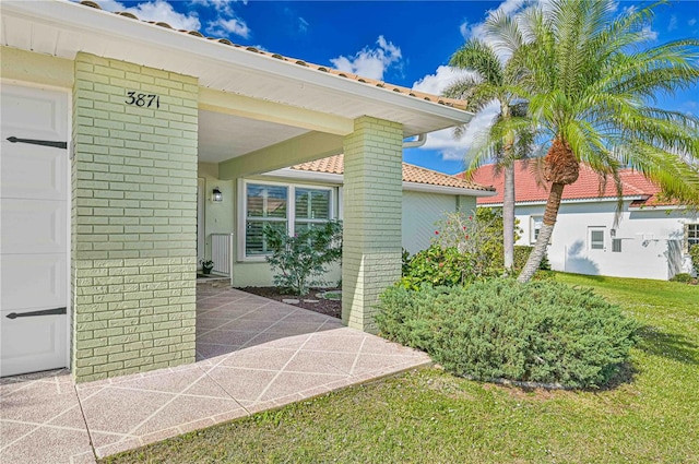 doorway to property featuring a lawn