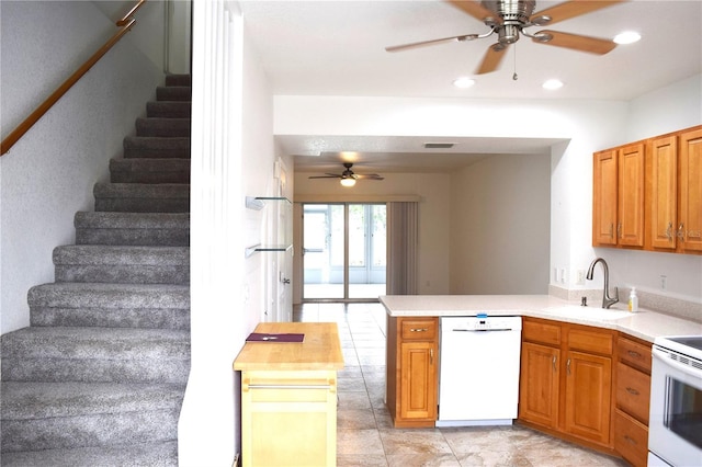 kitchen featuring sink, wooden counters, ceiling fan, kitchen peninsula, and white appliances