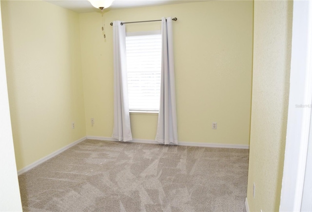 unfurnished room featuring light colored carpet