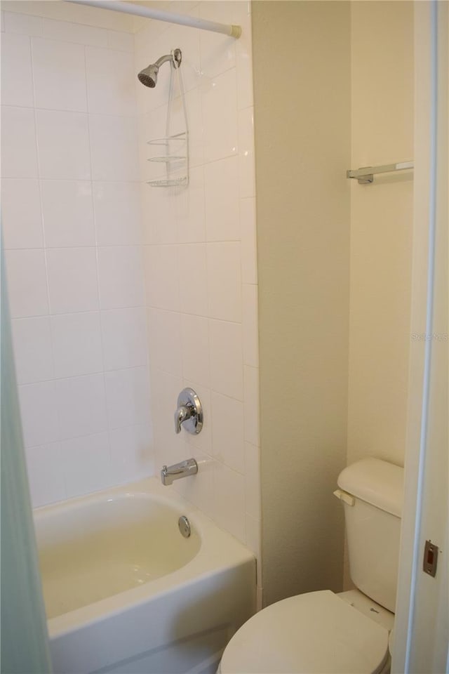 bathroom featuring shower / tub combo and toilet