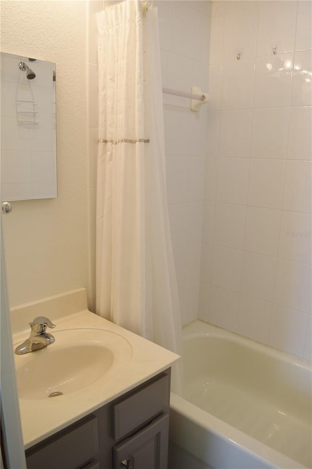 bathroom with vanity and shower / bathtub combination with curtain