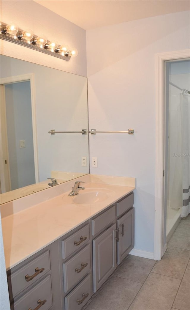 bathroom with vanity, tile patterned flooring, and curtained shower