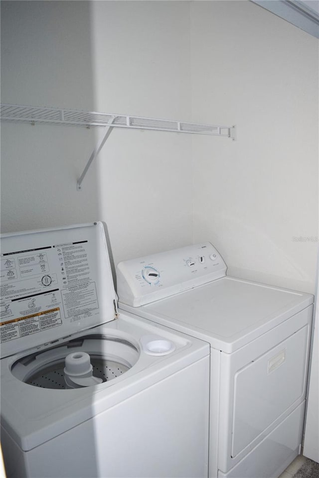 washroom featuring washer and clothes dryer