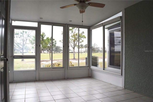 unfurnished sunroom featuring a wealth of natural light and ceiling fan