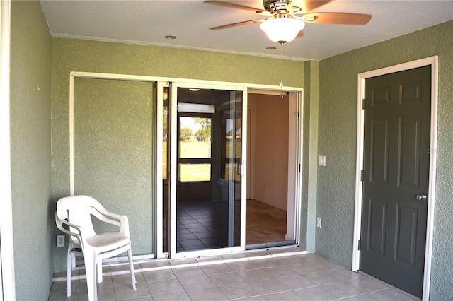 entrance to property featuring ceiling fan