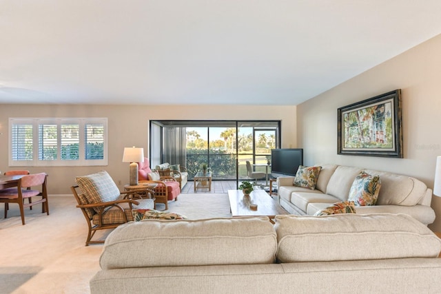 living room featuring a healthy amount of sunlight and light carpet