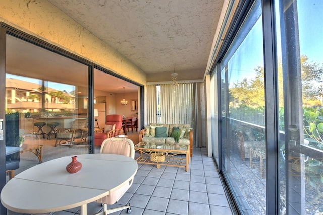 sunroom featuring a chandelier