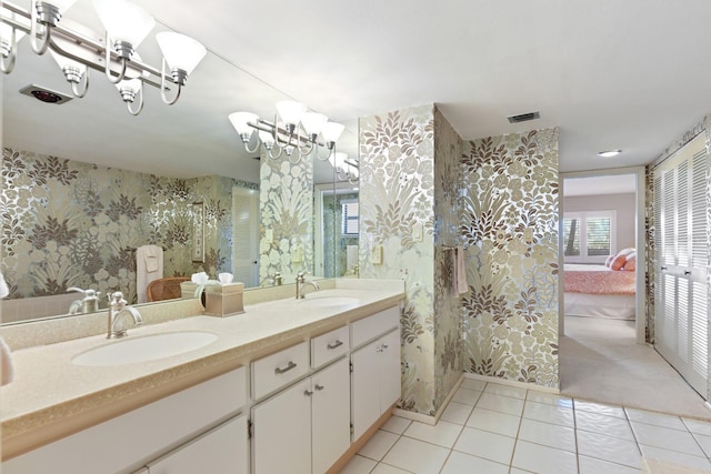 bathroom featuring vanity, tile patterned flooring, and a chandelier