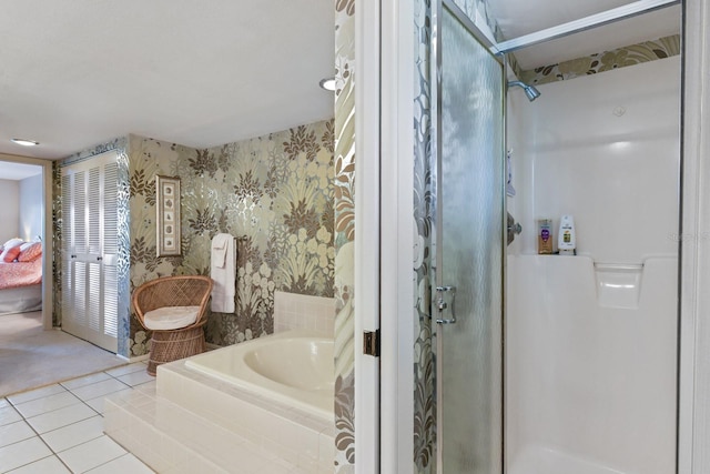 bathroom featuring tile patterned floors and independent shower and bath