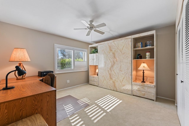 carpeted office space with ceiling fan