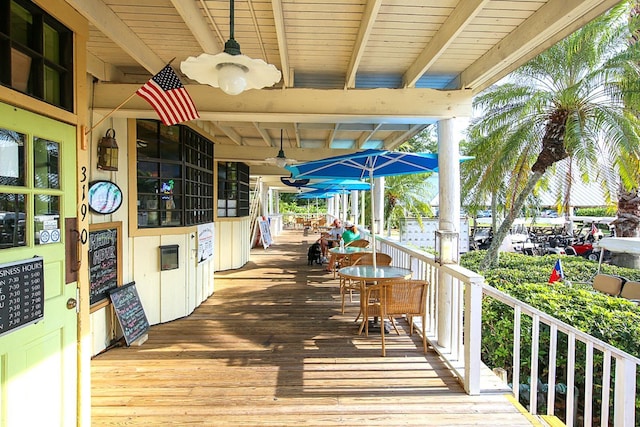 wooden deck featuring ceiling fan