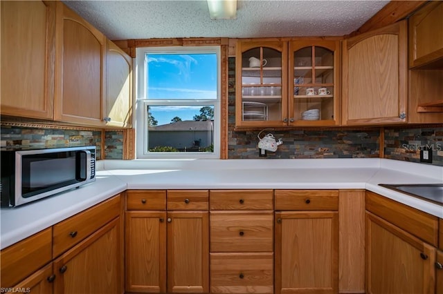 kitchen featuring tasteful backsplash, sink, and a textured ceiling