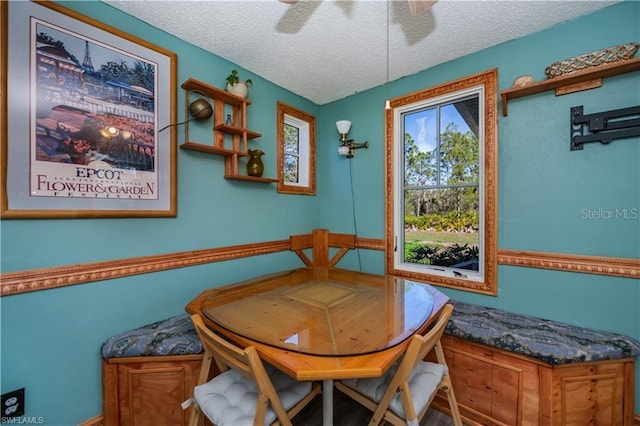 dining room featuring ceiling fan and a textured ceiling