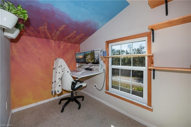 unfurnished office with lofted ceiling, carpet floors, and a healthy amount of sunlight