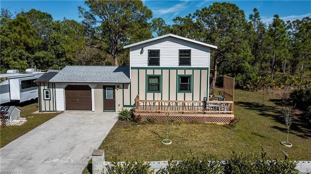 view of front of property with a porch, a garage, and a front lawn