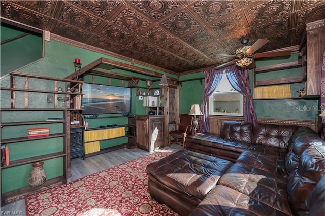 living room featuring crown molding, ceiling fan, and hardwood / wood-style floors