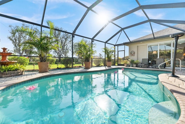 view of swimming pool featuring a patio and glass enclosure