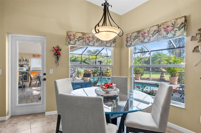 dining space featuring a wealth of natural light and light tile patterned flooring