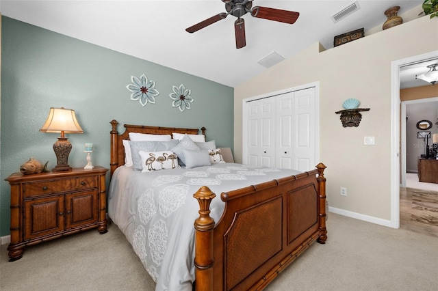 carpeted bedroom featuring vaulted ceiling, ceiling fan, and a closet