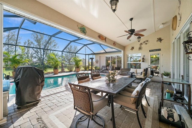 view of patio featuring a lanai, grilling area, and ceiling fan