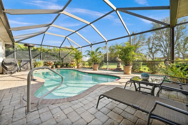 view of swimming pool featuring a lanai and a patio