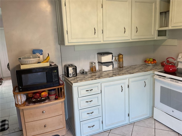 12077 Maryland Ave, Punta Gorda, FL 33955 - kitchen featuring backsplash, light tile patterned floors, and white electric range oven