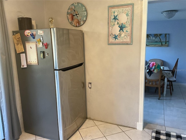 12077 Maryland Ave, Punta Gorda, FL 33955 - kitchen with stainless steel fridge and light tile patterned floors