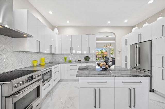 3415 Tripoli Blvd, Punta Gorda, FL 33950 - kitchen featuring stone counters, stainless steel appliances, wall chimney exhaust hood, white cabinets, and tasteful backsplash