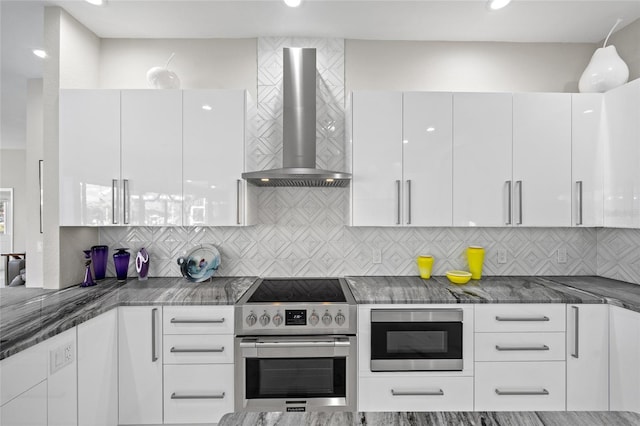 3415 Tripoli Blvd, Punta Gorda, FL 33950 - kitchen featuring stainless steel range with electric cooktop, wall chimney exhaust hood, white cabinetry, and built in microwave