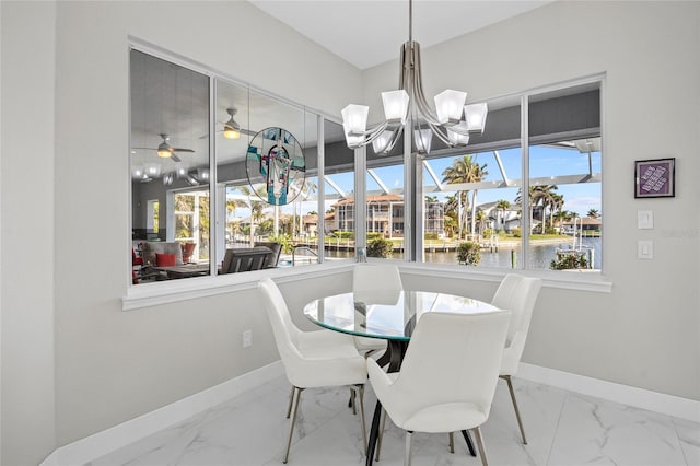 3415 Tripoli Blvd, Punta Gorda, FL 33950 - dining space with a water view and ceiling fan with notable chandelier