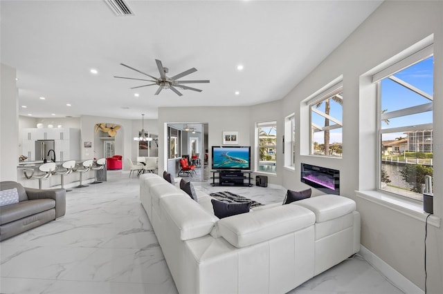 3415 Tripoli Blvd, Punta Gorda, FL 33950 - living room featuring ceiling fan with notable chandelier