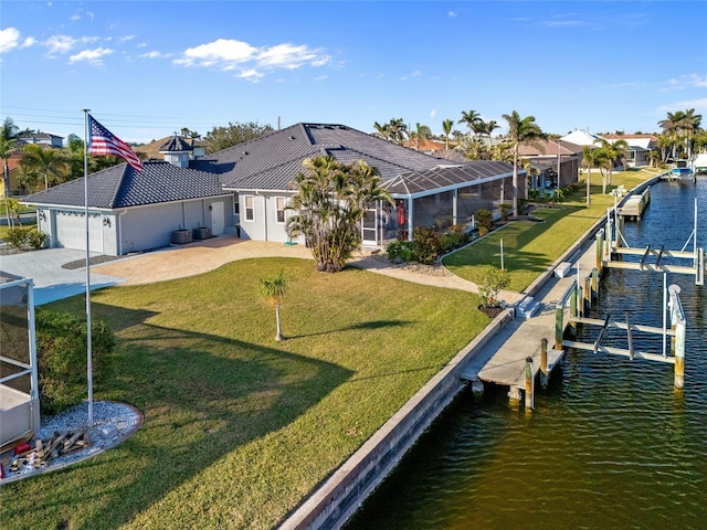3415 Tripoli Blvd, Punta Gorda, FL 33950 - view of dock featuring a lawn, a water view, and glass enclosure