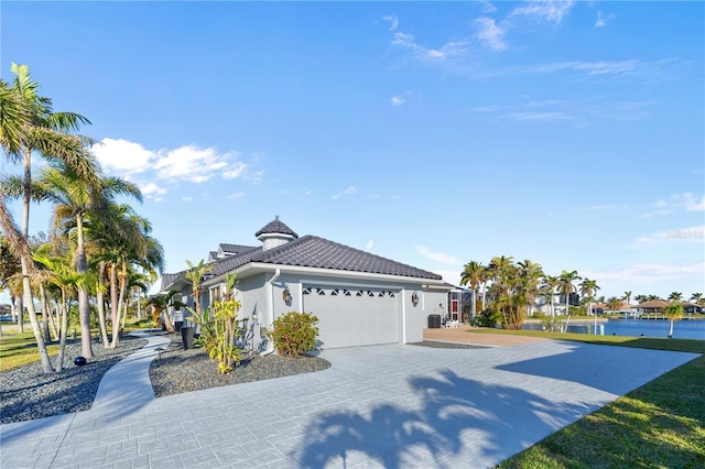 3415 Tripoli Blvd, Punta Gorda, FL 33950 - view of front of home with a garage and a water view